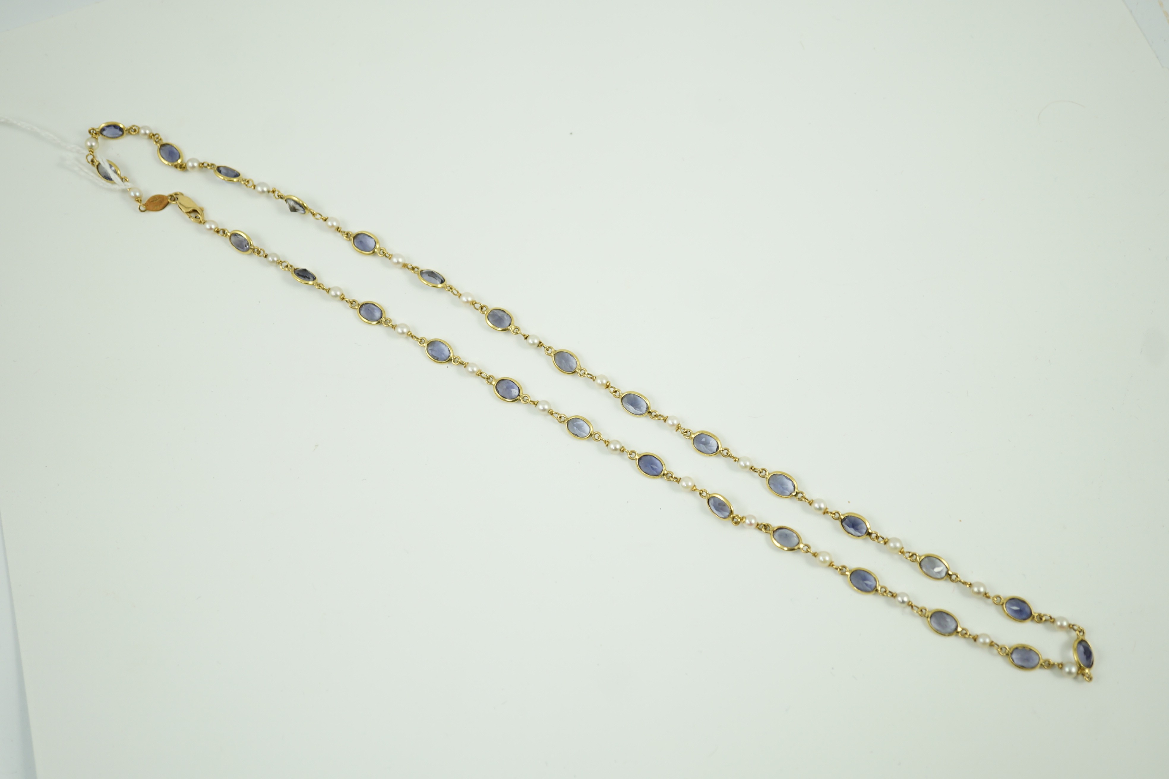 A modern 18ct gold, blue quartz and cultured pearl set spectacle necklace, 58cm, gross weight 15 grams.